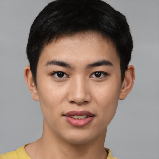 Joyful asian young-adult male with short  brown hair and brown eyes