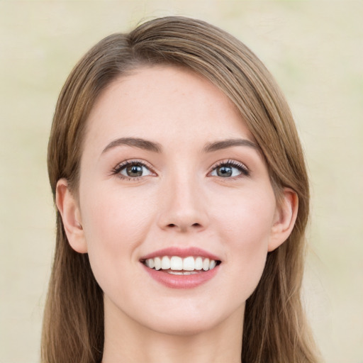 Joyful white young-adult female with long  brown hair and green eyes