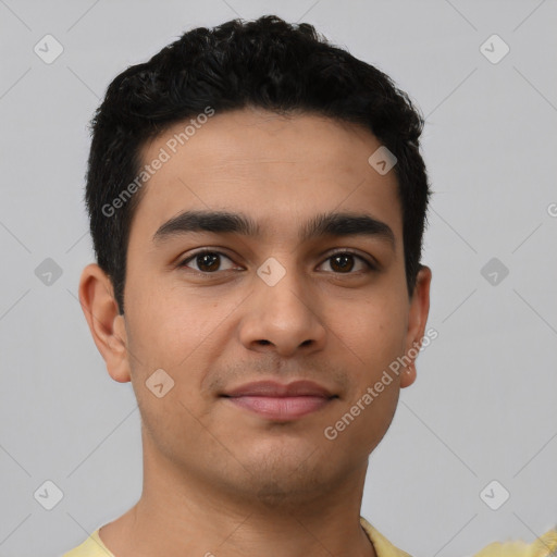 Joyful latino young-adult male with short  black hair and brown eyes