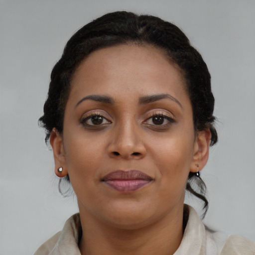 Joyful black young-adult female with medium  brown hair and brown eyes