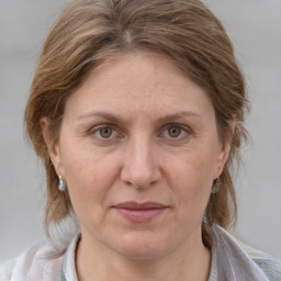 Joyful white adult female with medium  brown hair and grey eyes