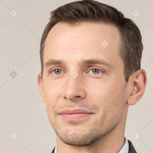 Joyful white young-adult male with short  brown hair and grey eyes