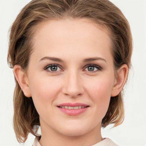 Joyful white young-adult female with medium  brown hair and green eyes