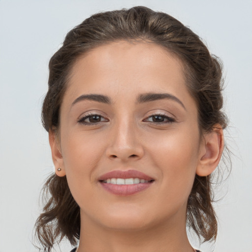 Joyful white young-adult female with long  brown hair and brown eyes