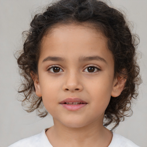 Joyful white child female with medium  brown hair and brown eyes