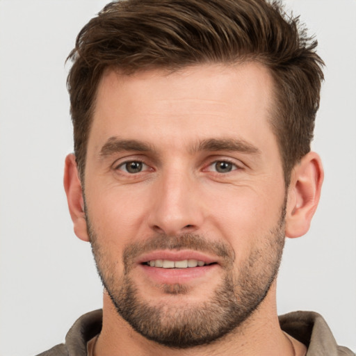 Joyful white young-adult male with short  brown hair and brown eyes