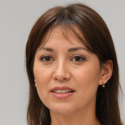 Joyful white adult female with long  brown hair and brown eyes