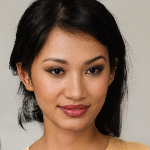 Joyful asian young-adult female with medium  brown hair and brown eyes