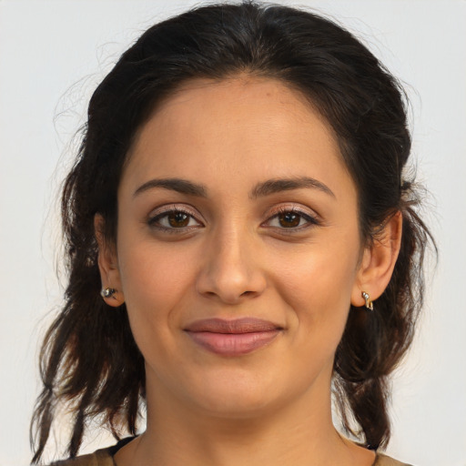 Joyful latino young-adult female with medium  brown hair and brown eyes