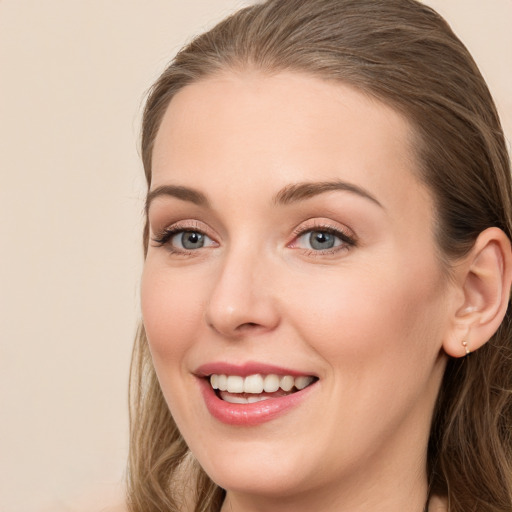 Joyful white young-adult female with long  brown hair and grey eyes