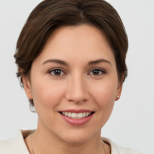 Joyful white young-adult female with short  brown hair and brown eyes