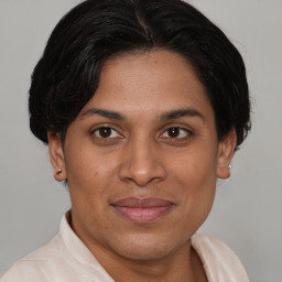 Joyful white adult female with short  brown hair and brown eyes