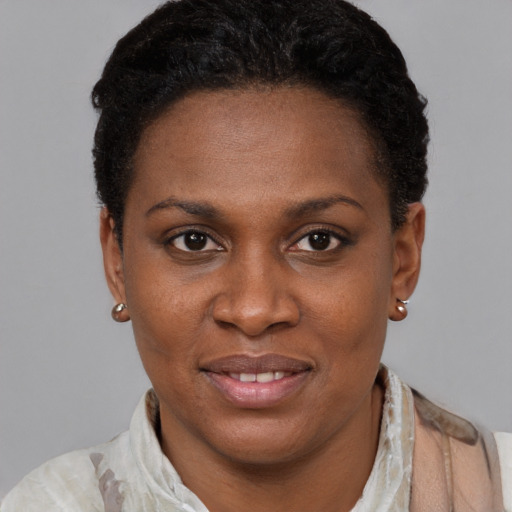 Joyful black adult female with short  brown hair and brown eyes