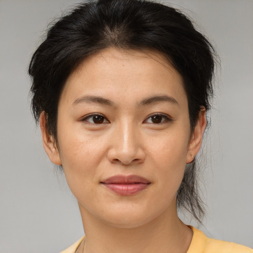 Joyful asian young-adult female with medium  brown hair and brown eyes