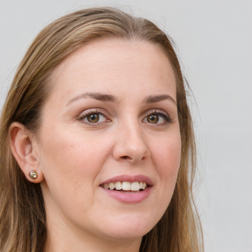 Joyful white young-adult female with long  brown hair and green eyes