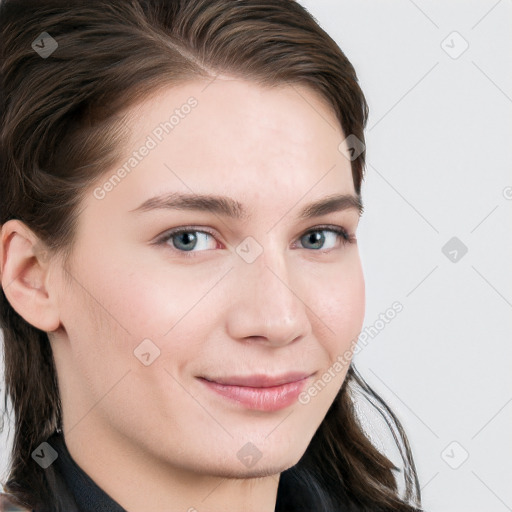 Joyful white young-adult female with long  brown hair and blue eyes