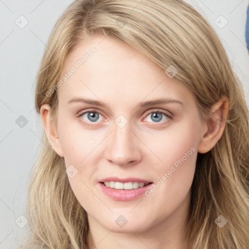 Joyful white young-adult female with long  brown hair and blue eyes