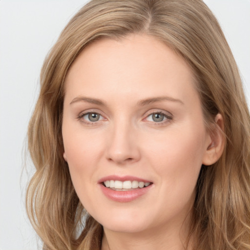 Joyful white young-adult female with long  brown hair and grey eyes