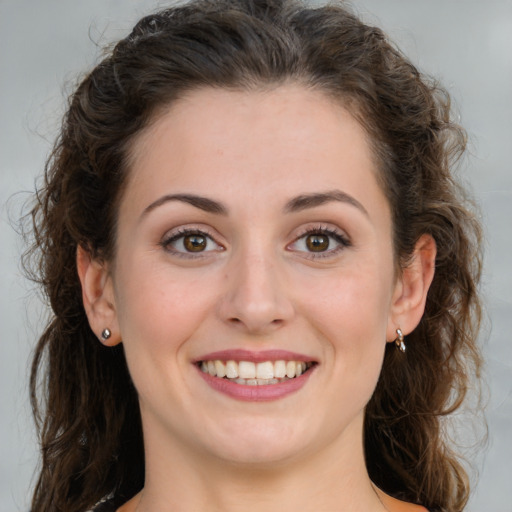 Joyful white young-adult female with long  brown hair and green eyes