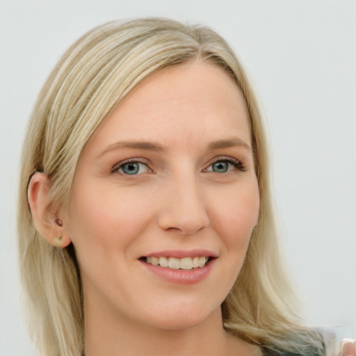 Joyful white young-adult female with long  blond hair and blue eyes