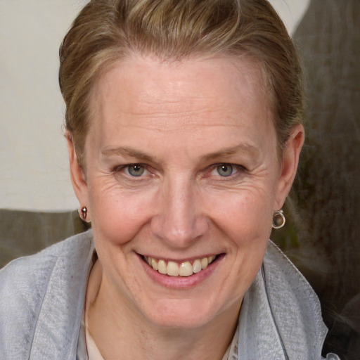 Joyful white adult female with short  brown hair and grey eyes