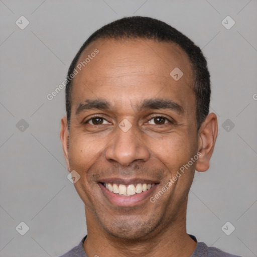 Joyful latino adult male with short  black hair and brown eyes