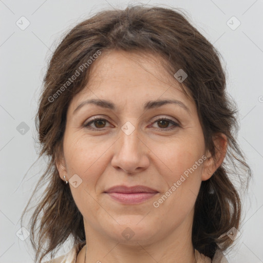 Joyful white adult female with medium  brown hair and brown eyes