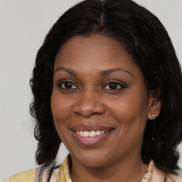 Joyful black young-adult female with medium  brown hair and brown eyes