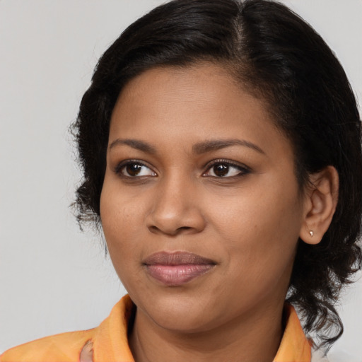 Joyful black young-adult female with medium  brown hair and brown eyes