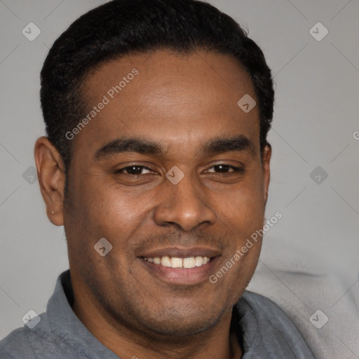 Joyful black young-adult male with short  brown hair and brown eyes