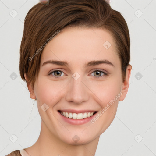 Joyful white young-adult female with short  brown hair and grey eyes