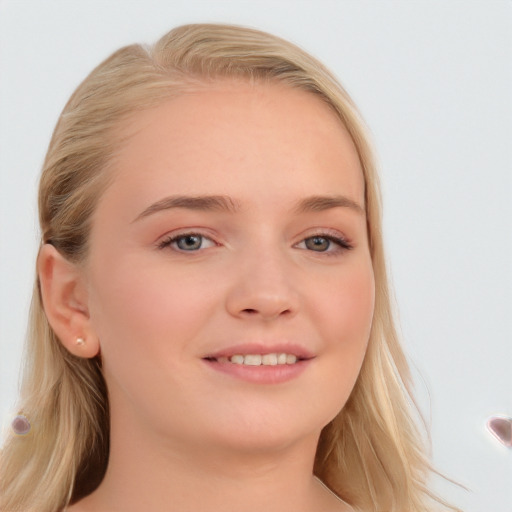 Joyful white young-adult female with long  brown hair and blue eyes