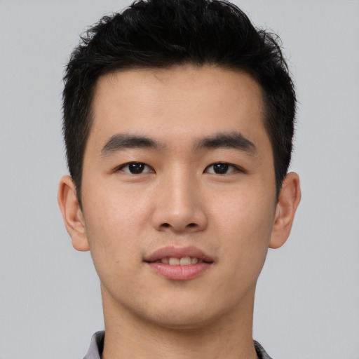 Joyful asian young-adult male with short  black hair and brown eyes