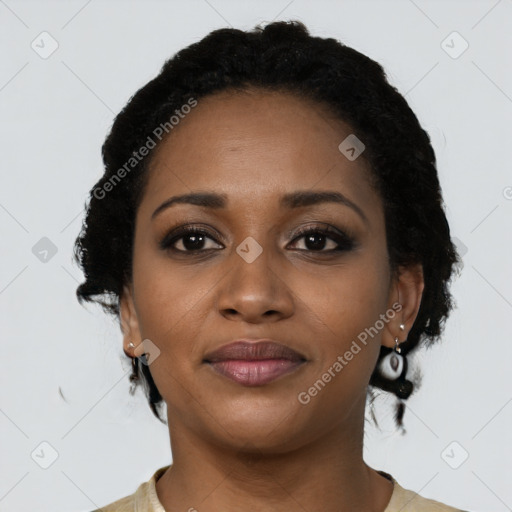 Joyful black young-adult female with short  black hair and brown eyes
