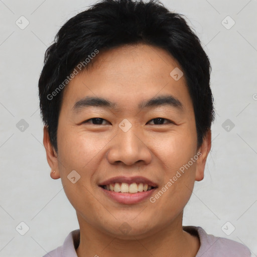 Joyful asian young-adult male with short  black hair and brown eyes