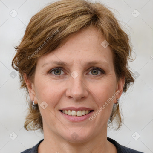 Joyful white adult female with medium  brown hair and grey eyes