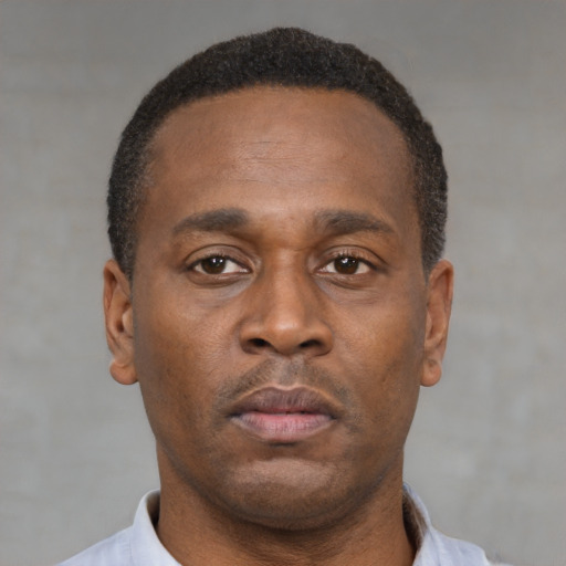 Neutral latino adult male with short  brown hair and brown eyes