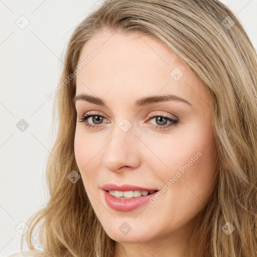 Joyful white young-adult female with long  brown hair and green eyes