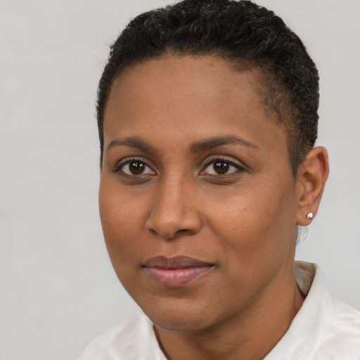 Joyful black young-adult female with short  brown hair and brown eyes