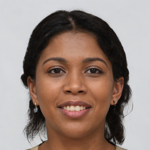 Joyful black young-adult female with medium  black hair and brown eyes