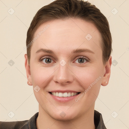 Joyful white young-adult female with short  brown hair and grey eyes