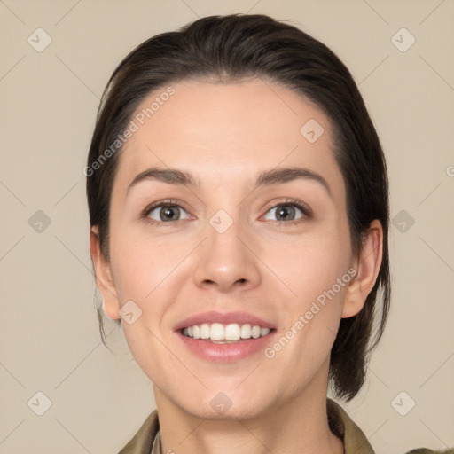 Joyful white young-adult female with medium  brown hair and grey eyes