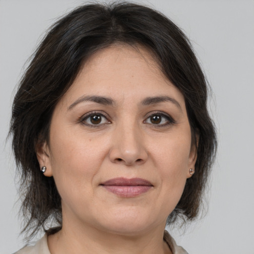 Joyful white adult female with medium  brown hair and brown eyes