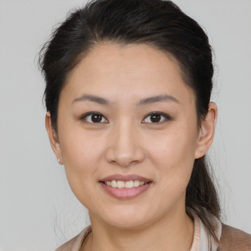 Joyful white young-adult female with medium  brown hair and brown eyes