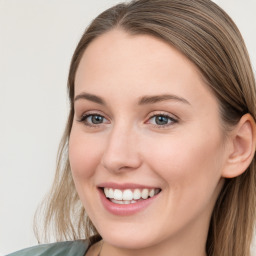 Joyful white young-adult female with long  brown hair and blue eyes