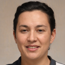 Joyful white adult female with medium  brown hair and brown eyes