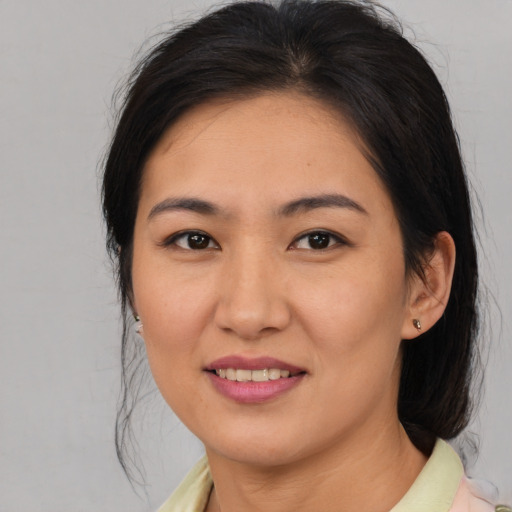 Joyful asian young-adult female with medium  brown hair and brown eyes