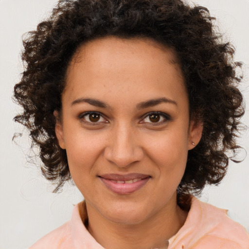 Joyful black young-adult female with medium  brown hair and brown eyes