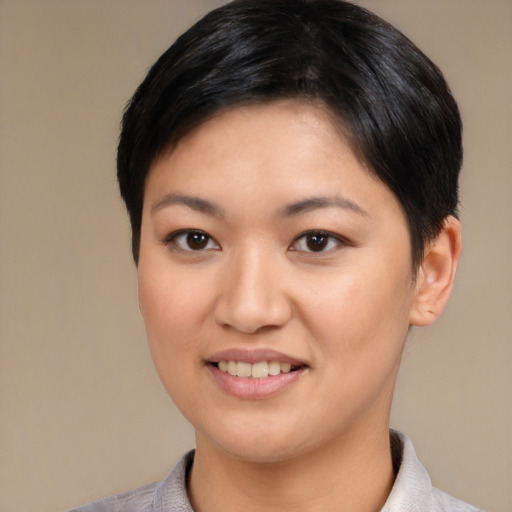 Joyful asian young-adult female with short  black hair and brown eyes