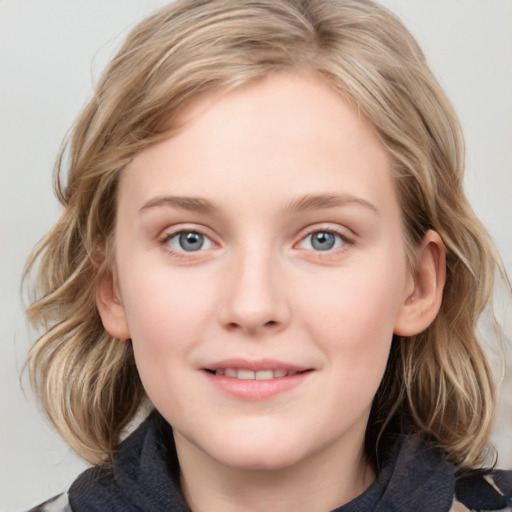 Joyful white young-adult female with medium  brown hair and blue eyes